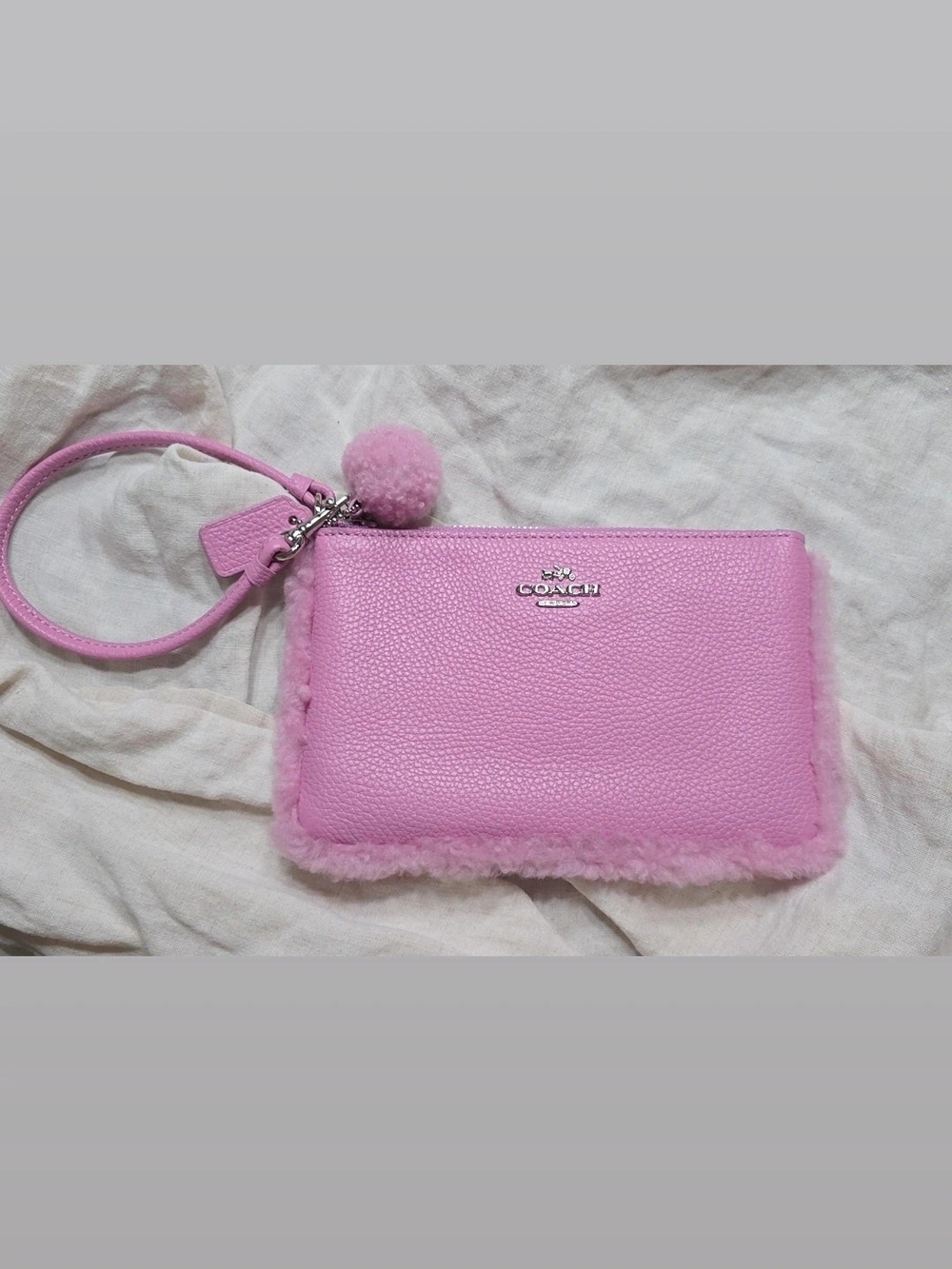 COACH Pink Pebble Leather Wristlet with Pom-Pom Trim